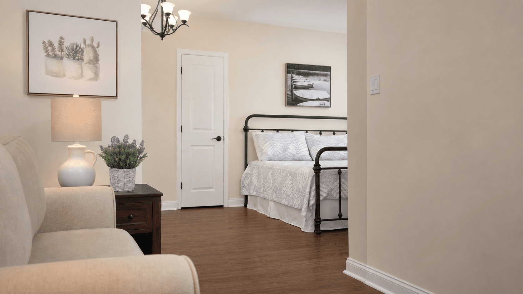 A studio suite with a couch, lamp, and bed at Tiffany Village